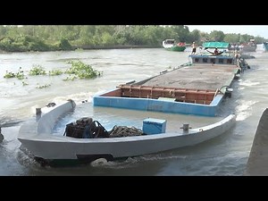 Dangerously Overloaded Barges Forcing Their Way Through the Dam Gate