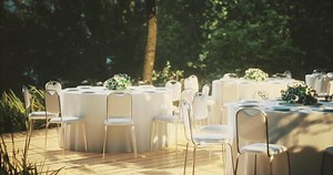 CGI Elegant outdoor wedding setup featuring white tables and floral arrangements