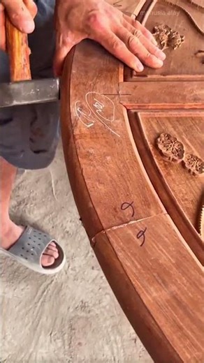 fixing wooden round table joint by inserting small piece of wood and hammering it until it is firm