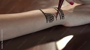 Woman draws mehendi on the hands in a beauty salon. Traditional body art. Indian tradition. 4K