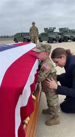 Emotional Tributes: Soldier's Son Beside Flag-Draped Casket
