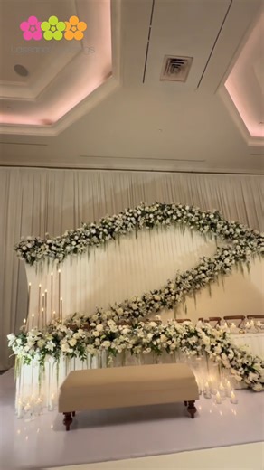 Piumika & Nipun | Hilton Ballroom ✨ A vision of timeless elegance, where tradition meets innovation. For this special day, we brought to life a unique concept — blending the grandeur of the head table with the charm of the settee back, creating a centerpiece that redefined sophistication. 🌸🤍 Take a walk with us through one of our most cherished wedding setups of the season. #LassanaWeddings #HiltonWedding #WeddingElegance #WeddingDesign #LuxuryWeddings #UniqueCenterpieceDesign | Lassana Flora 