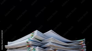 Key frame of 4K-Stop motion Stack overload document report paper with colorful paperclip on black background and copy space, business concept footage paperless used.