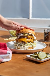 A juicy smash patty sandwiched between spicy ranch and garlic bread buns. Bet you can't name a better duo 🍔😮‍💨 | New World