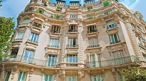 Cinematic view of French buildings in Paris. Historical old landmarks of Paris, architectural buildings. Typical Parisian building with balconies and windows in France.