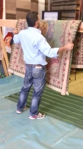 Dusty Kerman rug beating