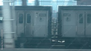 Looking out the window of a New York City subway train in motion (Manhattan to Brooklyn) seeing another train at same speed going over the Manhattan Bridge with the skyline in the background. POV shot Stock Video