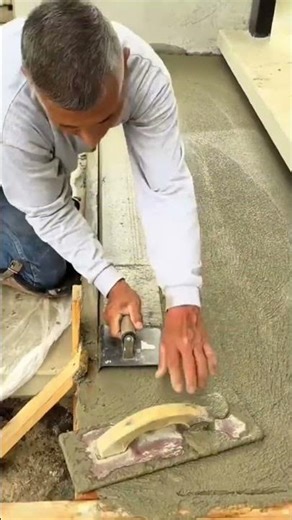 This man demonstrates how to smooth out rough cement on the floor and make it smooth #construction