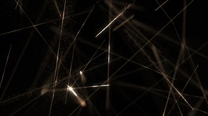 Glowing golden laser beams motion background with shiny exploding particles and flashing fast moving lasers. This science and technology background animation is full HD and a seamless loop.