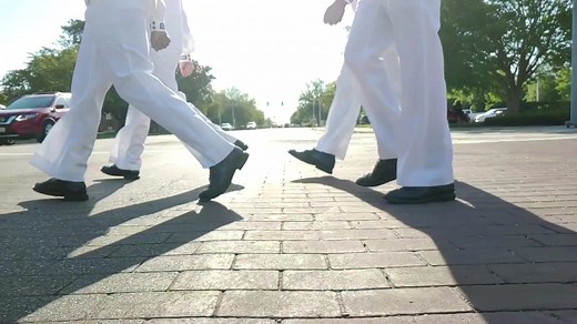 Morning and evening colors is a time honored Navy tradition. For military service members and civilians living and working on Naval Station Norfolk and all other Navy Installations, beginning and ending each day honoring the American Flag is a reminder of why they serve this great nation. The base literally comes to a stand-still in the morning promptly at 8 a.m. with traffic stopped and anyone in uniform standing at attention, saluting the nearest flag. Civilians will stop and place their hand