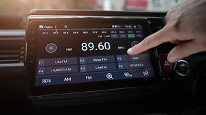 Man finger changing car audio equalizer settings using smart multimedia, modern touch screen audio stereo system, transportation and vehicle concept, close up with selective focus