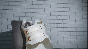 Corset for back. A view of plastic corset lay on the chair by the wall in the room. A concept of scoliosis healthcare at home.