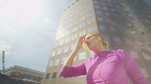 Attractive female runner stretching in the city in slow motion