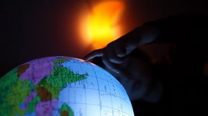 boy pointing at globe