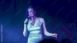 Beautiful blue hair female stand-up comedian performing on stage