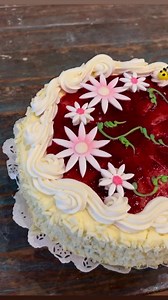 3.1K views · 89 reactions | The Bumbleberry Torte One of our most beautiful cakes starts with a light, delicated genoise cake. Its filled with white chocolate ganache and cream cheese filling that sits atop a layer of locally made raspberry preserves. Its wrapped in white chocolate curls and topped with more raspberry, French vanilla buttercream and elegant summer decor! | The BonBonerie | Facebook