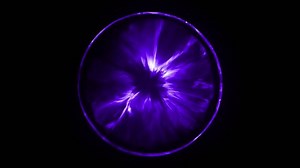 Violet electronic light effects in an abstracted crystal ball in a dark background