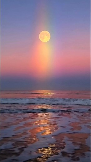 53K views · 3K reactions | A moonrise above the ocean, painted with a radiant vertical rainbow. The full moon glows high in the twilight sky while its light creates a magical spectrum from blue to rose to gold, shimmering across the gentle waves and wet sand. Nature’s poetry, where night and color quietly meet. #Moonbow #RainbowNights #TwilightMagic #CelestialArt | Sky&Earth | Facebook