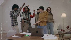 Joyful Happy college students dancing and then studying together. Group of multiethnic friends smiling and studying with laptop. High School young women and men calculating using computer