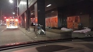 Sidewalk Encampment ... Homeless person sleeping on a downtown...