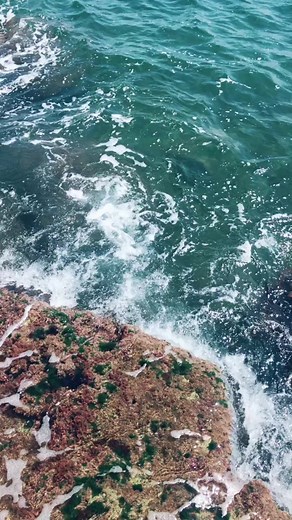 Coastal Serenity: Waves and Rocky Shoreline Beauty