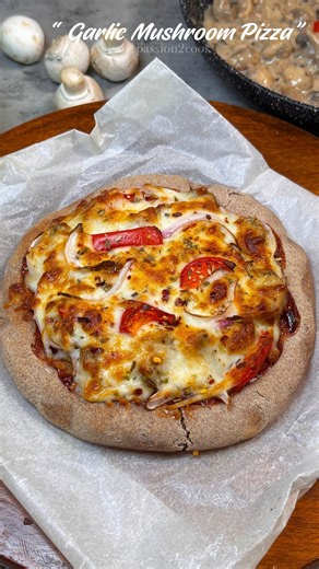 This garlic mushroom pizza has a nutritious wheat and ragi flour crust, topped with sautéed garlic and mushrooms. It's cooked in the airfryer for a quick, crispy, and delicious meal with less oil, perfect for a healthy homemade pizza option. #GarlicMushroomPizza #HealthyPizza #AirfryerPizza #HomemadePizza #WholeGrainPizza #RagiPizza #VegetarianPizza #HealthyEating #QuickMeals #PizzaLovers | Passion2cook