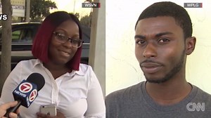 Man calls 911 while clinging to hood of a car