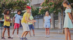 Group of kids playing with chinese jumping rope outdoors. Boys and girls having fun together.