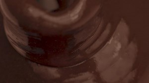 Liquid chocolate flowing into a chocolate fountain - Free Stock Video