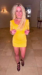 Britney Spears shows off her dance moves as she wears a yellow dress