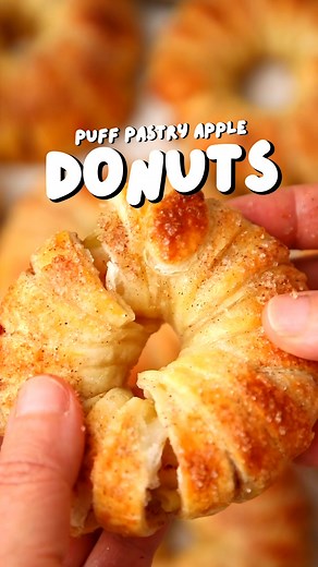 Puff Pastry Apple Donuts (full recipe below👇) INGREDIENTS 2 sheets of puff pastry ¼ cup granulated sugar 2 tsp ground cinnamon 4 large apples 1 egg, lightly beaten DIRECTIONS Preheat oven to 400°F. In a small bowl, mix sugar and cinnamon. Set aside. Slice the apples crosswise into rounds about ¾ inch thick. Use a small round cutter or corer to remove the seeds from each apple slice. Roll out each puff pastry sheet and cut into strips about 1 inch wide. Place one apple slice at the end of a past
