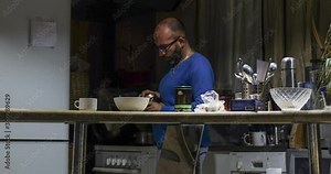 Timelapse of the process of creating dinner and eating a tasty and mouth-watering hot dish with smoke and steam, in the kitchen with a breakfast bar in a dark room