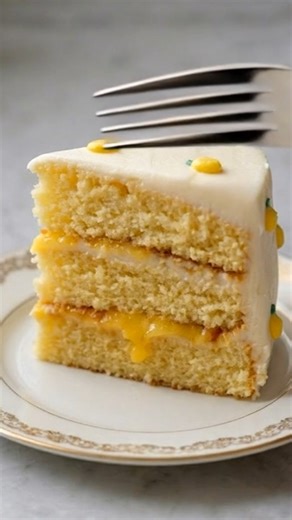 🍋 BEST Easy Lemon Layer Cake | Ultra Moist, Bakery-Style & Irresistible ✨ This Easy Lemon Layer Cake is sunshine in cake form. Soft, ultra-moist lemon cake layers filled with bright lemon cream and wrapped in silky smooth frosting — every bite is fresh, fluffy, and packed with real lemon flavor. The secret? That vibrant lemon layer in the middle that melts right into the cake. It’s sweet, tangy, and completely crave-worthy. And those tiny piped lemons on top? The cutest bakery-style finish. You