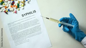 Syphilis diagnosis written on paper hand holding medication in syringe treatment