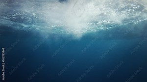 Beautiful underwater sea scene view with natural light rays, slow motion, the water glittering and have moving surface, caustics, bubbles, and foam, perfect for background and digital composition