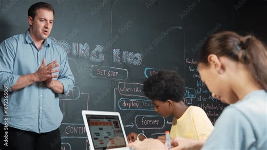 Teacher teaching about coding system while diverse academic student fixing main board at table with laptop display programming prompt or engineering code at STEM technology classroom. Edification