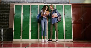 Girl friends, phone and school hall with funny joke, meme and social media together by locker. Education, gossip and teenager kids with mobile and internet scroll of student with laughing and talking