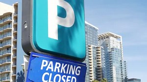 Parking lot sign as symbol of traffic difficulties and transportation issues in busy urban areas of USA. Public paid parking zone in downtown of San Diego, California. Limited space for cars in city