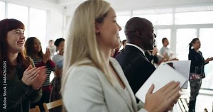 Stand out presentations get standing ovations. Diverse group of business people smiling and clapping with a standing ovation at a conference, applauding during a corporate training seminar meeting