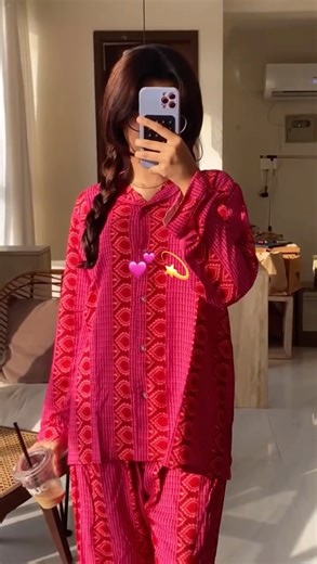 5.9K views · 15 reactions | Pink Paradise 臨 This pink and red pjs set with a mix of patterns – stripes and geometric designs is bold and beautiful. The shirt has buttons down the front, and the pants match the vibe. She’s rocking it with some iced coffee 﫶 | That Girl | Facebook