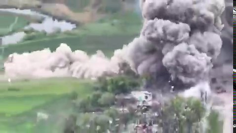 SYMPATHETIC TARGET: This is combat footage of a Russian front line ammo depot cooking off. A fire blazes, likely from mortar round propellants (increments). And as the fire spreads, it detonates artillery shells.
