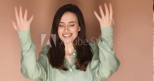 Surprised excited happy woman on beige background. Girl shows yes gesture victory, she achieved result, goals. Wow, it is awesome. Surprised girl face. Close up of shocked woman face expression.