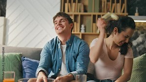 Married gamers enjoy playing video game at couch close up. Family entertainment