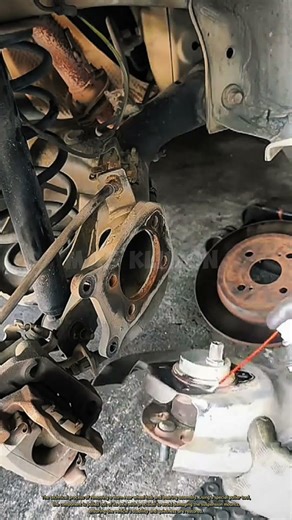 The technical process of removing a worn rear wheel hub and bearing assembly.