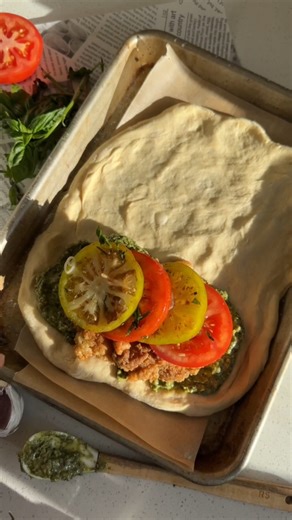 Greg | Vegan Comfort Food Recipes on Instagram: "Chicken pesto 🤝 calzone. You already know I’m team calzone and I couldn’t resist stuffing it with these heirloom tomatoes alongside my favourite battered and fried tofu recipe and homemade vegan pesto 😍 get the full holiday dinner recipe here and let me know what needs to go inside the next pocket of dough below!! #plantbased #calzone #pesto #veganchicken #heirloomtomatoes INGREDIENTS: For The Pesto: - 3/4 cup cashews (or sunflower seeds) - 1/4 