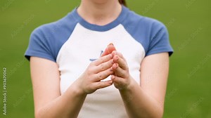 Close-up of woman's hands clapping. The girl claps and gives a thumbs up.