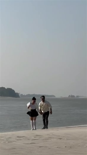 Leisurely Beach Walk: A Couple's Serene Stroll
