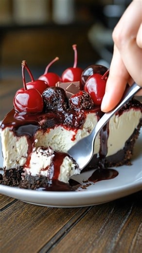 No-Bake Black Forest Berry Cheesecake 🍒🍫 Ingredients: - 300 g chocolate sandwich cookies, crushed - 120 g melted butter - 400 g cream cheese, softened - 200 g cottage cheese - 120 g powdered sugar - 1 teaspoon vanilla extract - 250 ml cold heavy whipping cream - 30 g cocoa powder - 200 g mixed berries (cherries, strawberries, raspberries) - 2 tablespoons lemon juice - 80 g dark chocolate, grated or shaved Directions: 1. In a large bowl, mix the crushed chocolate cookies with melted butter unti