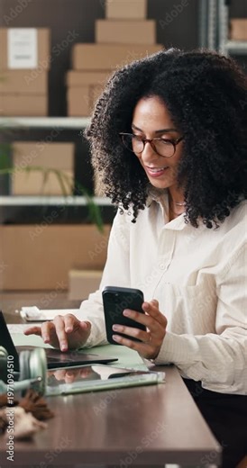 Boxes, laptop and phone with woman in logistics plant for management of shipping schedule. Reading, technology and typing with employee person in supply chain office for delivery or distribution