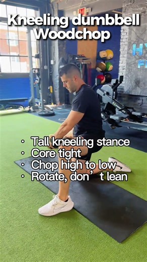 Kneeling dumbbell woodchops are great for building rotational strength and core stability.